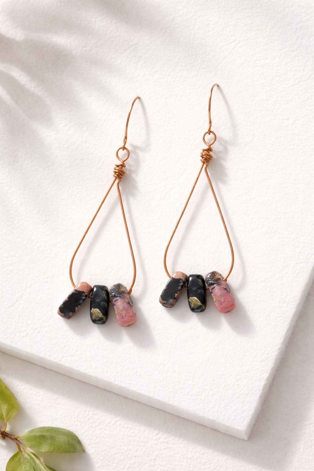 Pair of earrings with natural stone beads on a white background