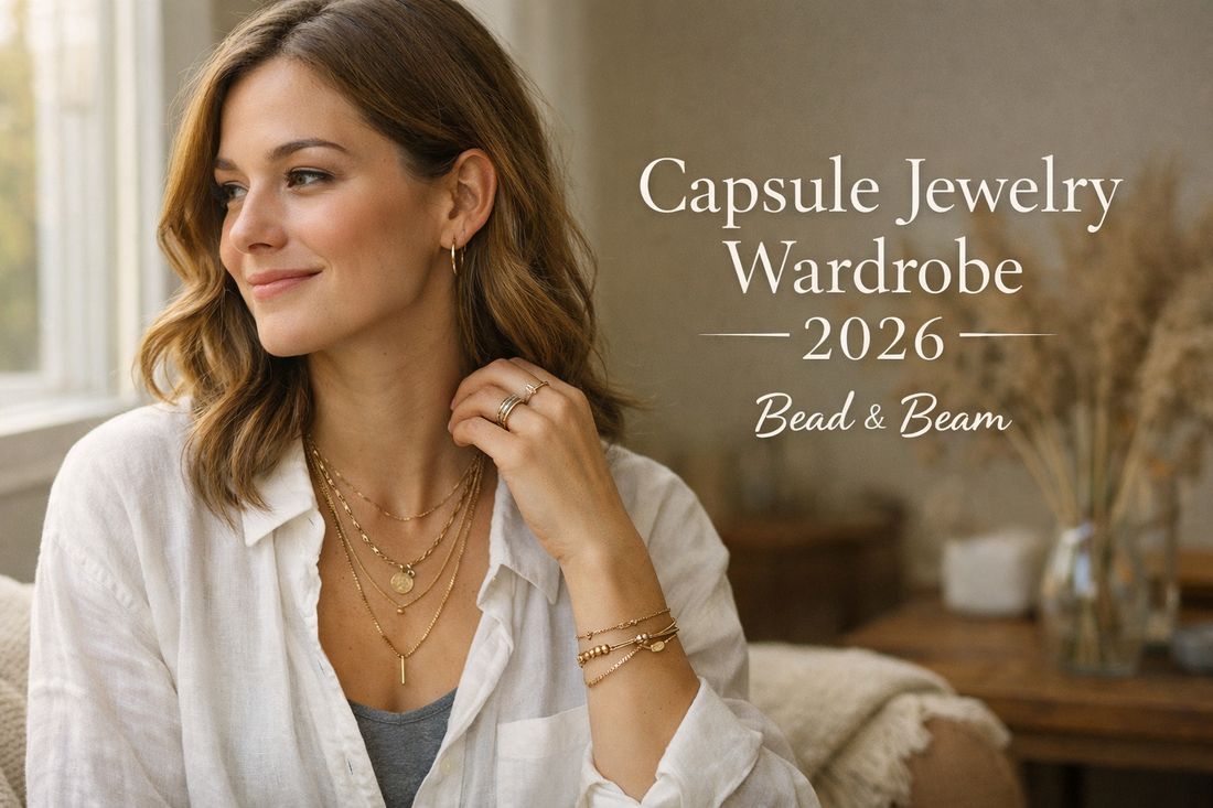 Lifestyle photo of a woman layering gold necklaces, rings, and hoop earrings, promoting a capsule jewelry wardrobe for 2026 by Bead & Beam.