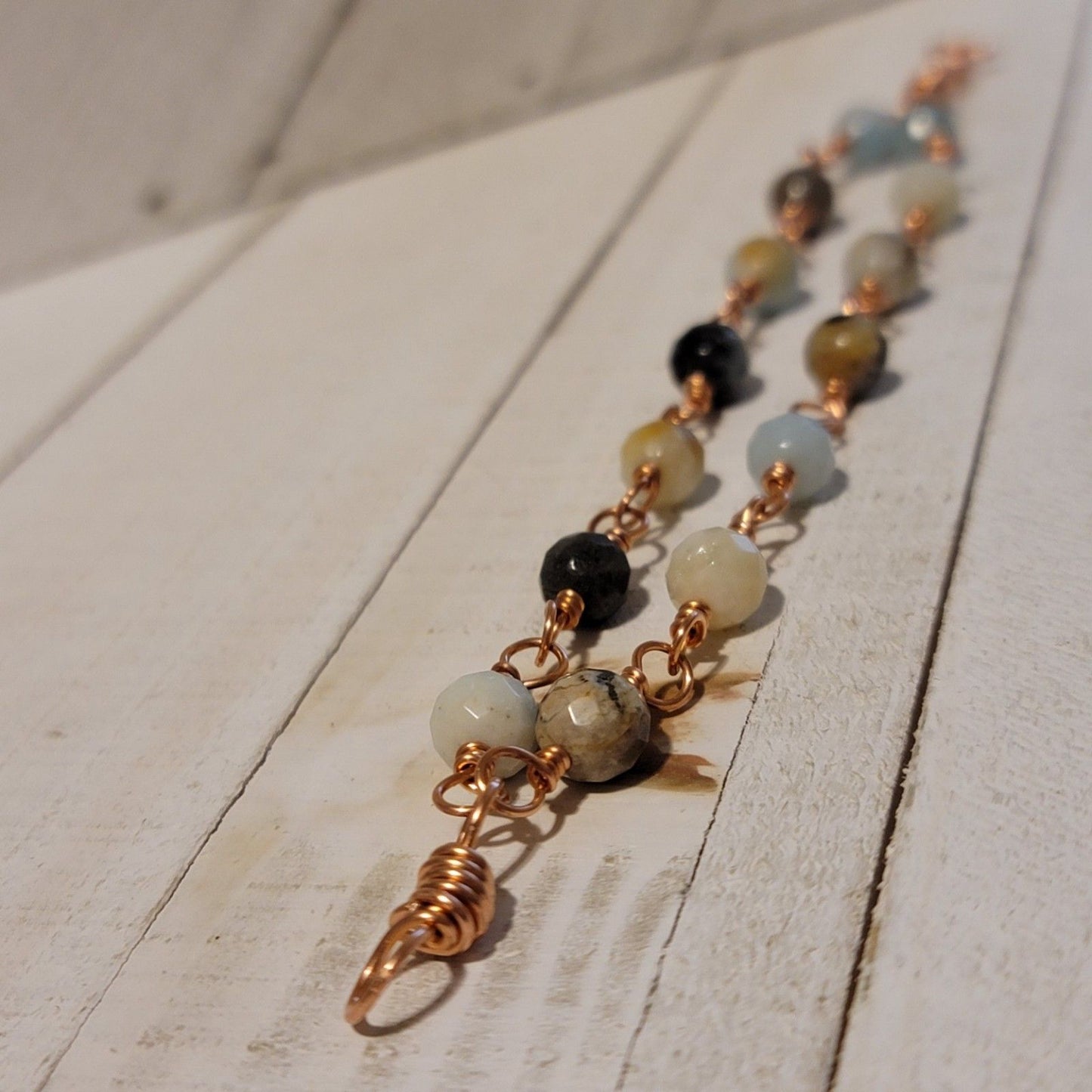 Necklace with multicolored beads and gold accents on a wooden surface