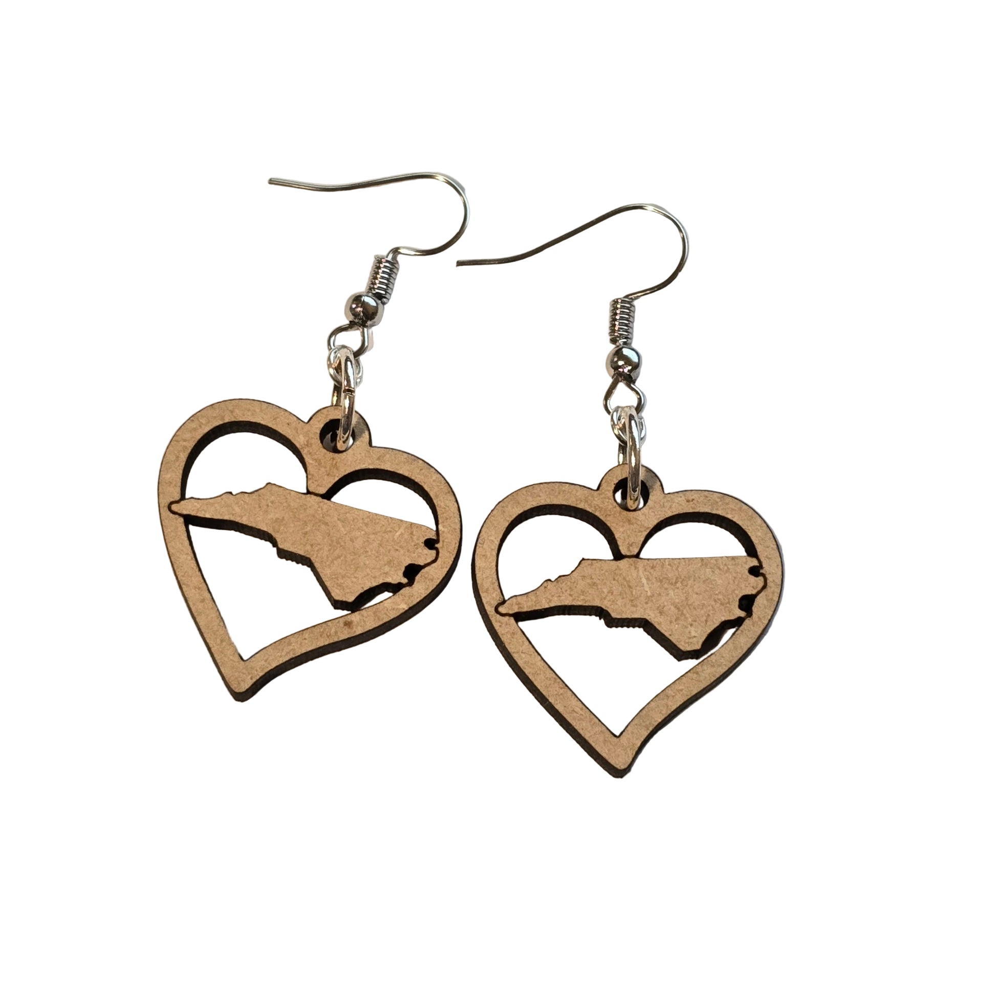 Heart-shaped earrings with a silhouette design on a beige background