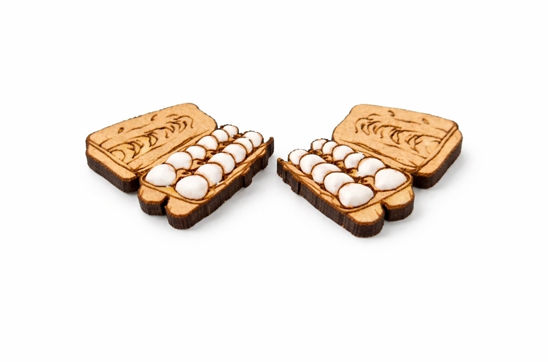 Wooden earring set with egg-shaped pieces on a white background