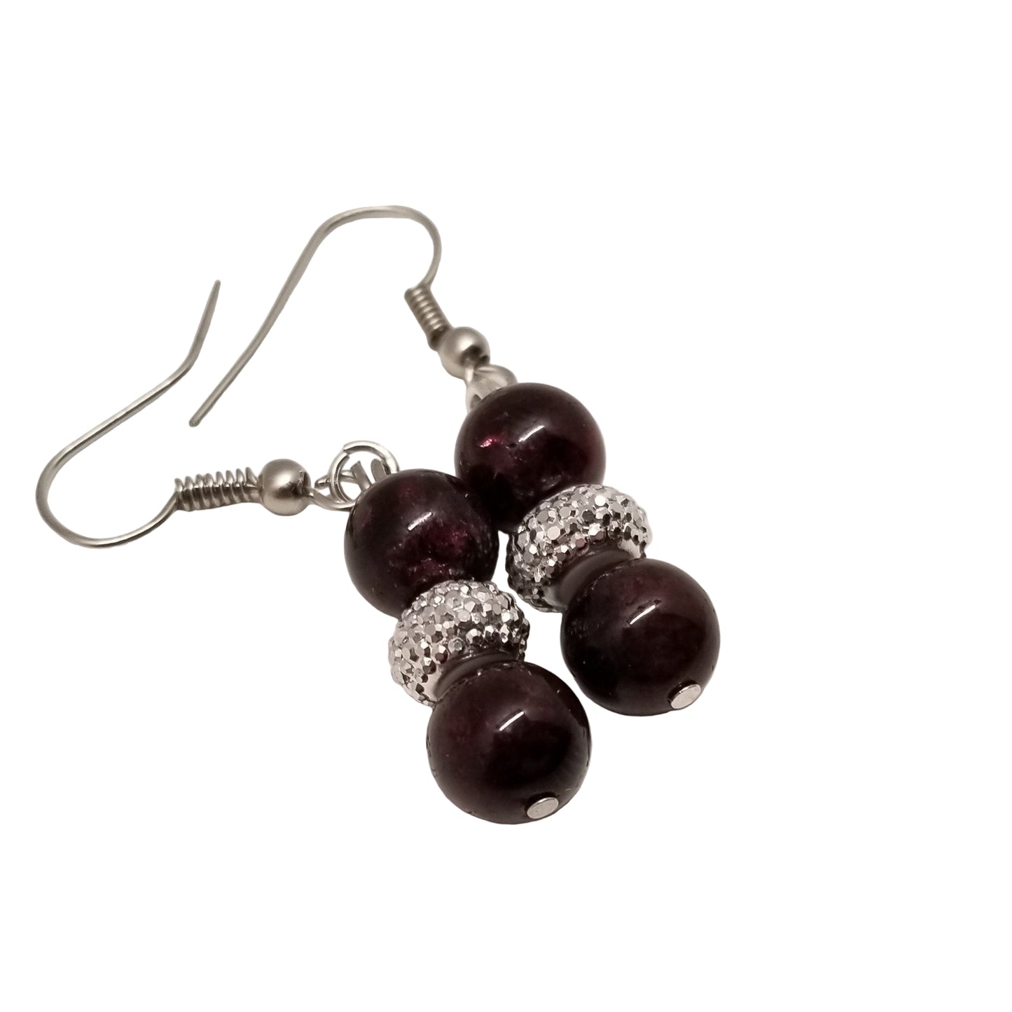 Pair of earrings with dark beads and silver accents on a white background