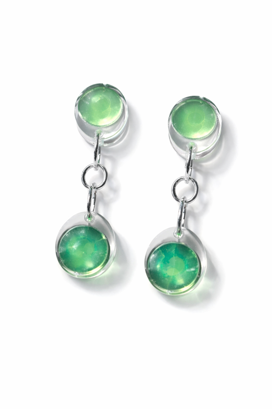 Pair of earrings with green gemstones on a white background