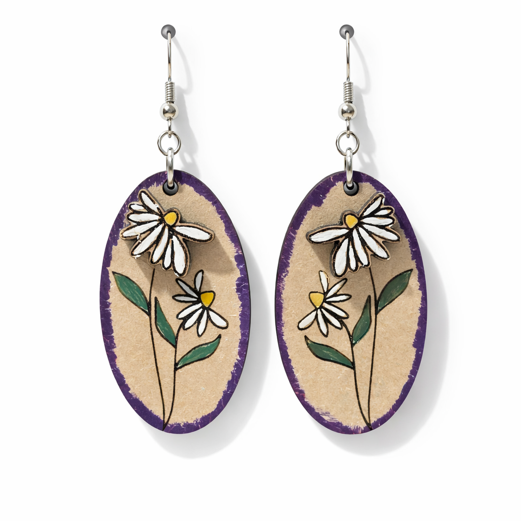 Oval-shaped earrings with floral designs on a beige background