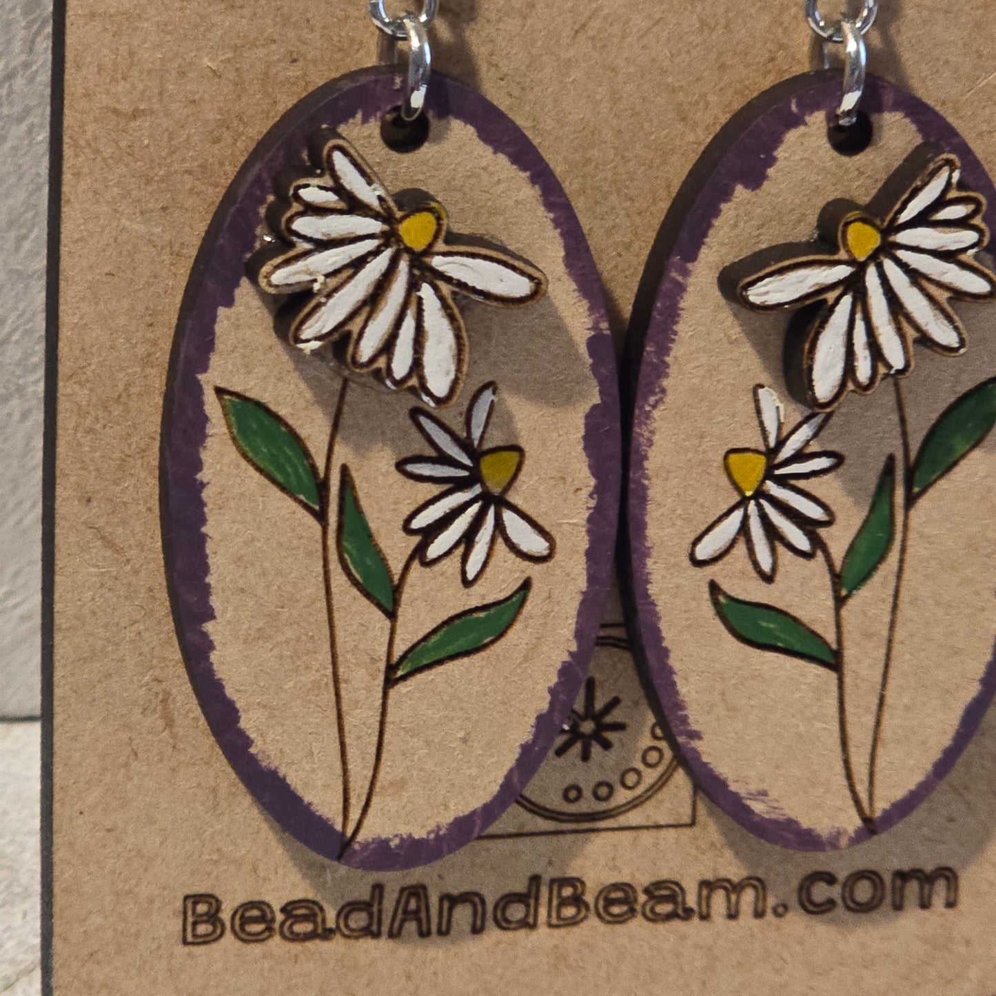 Pair of floral earrings on a cardboard backing with 'BeadAndBeam.com' branding.