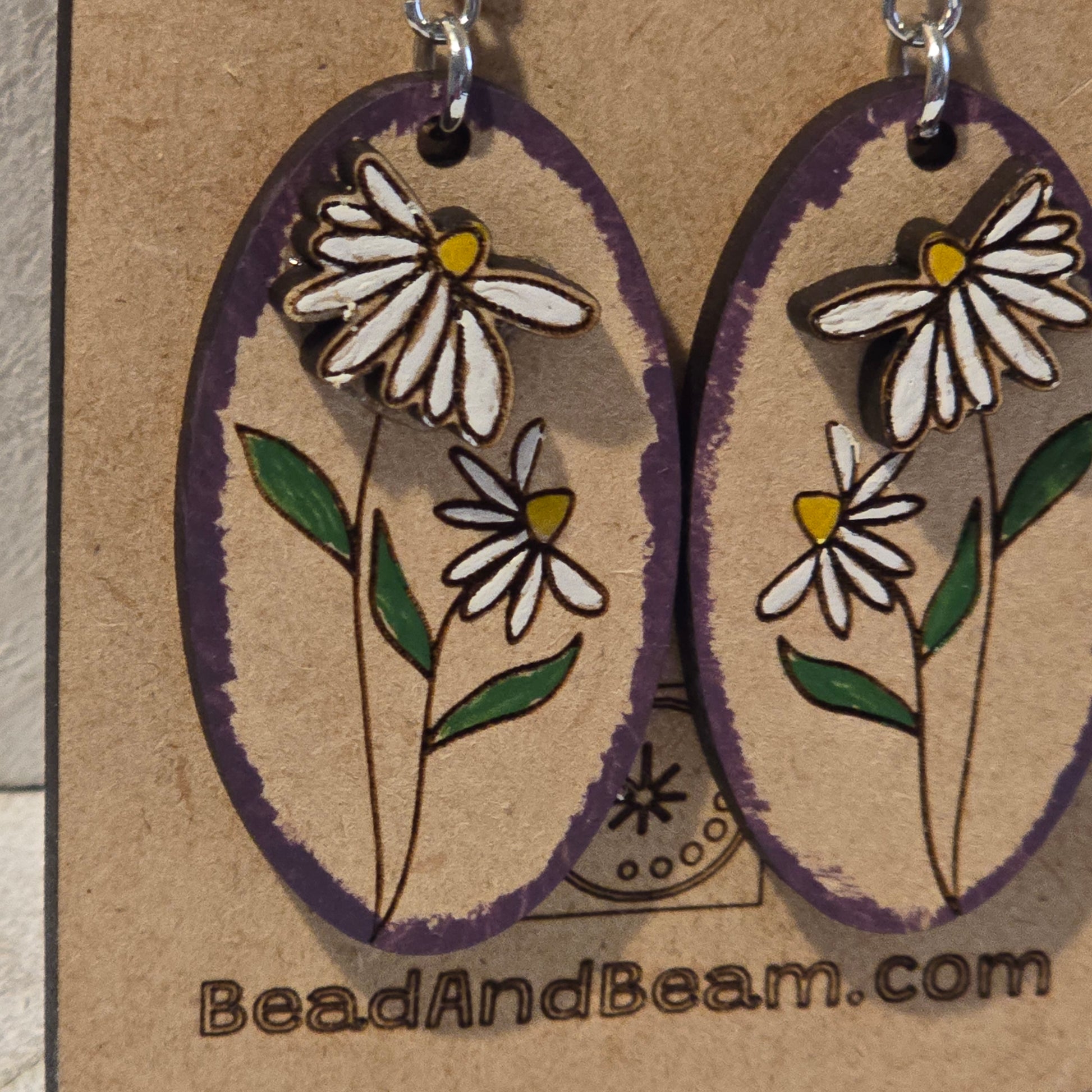 Pair of floral earrings on a cardboard backing with 'BeadAndBeam.com' branding.